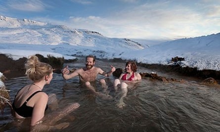 Friends relaxing in Reykjadalur hot springs in Iceland