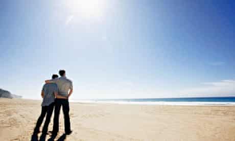 Gay couple standing on a beach