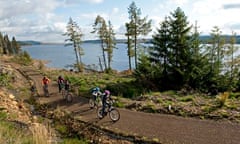 Family cycling along the Lakeside Way, Kielder Water and Forest Park, Northumberland