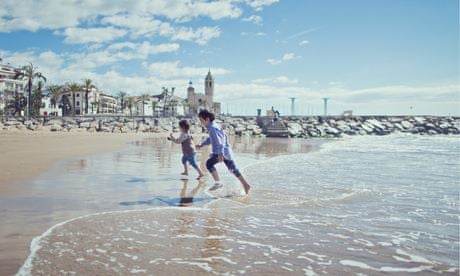 Siblings playing at the seaside, Sitges, Spain