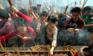 Visitors burn joss sticks and pray at Wong Tai Sin Temple in Hong Kong