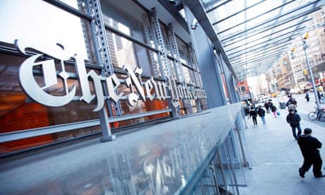 Pedestrians walk past the New York Times headquarters in New York