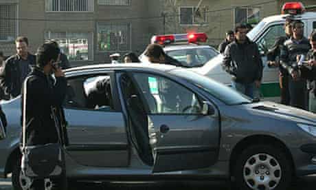 Iranian police beside the car in which Majid Shahriari was killed