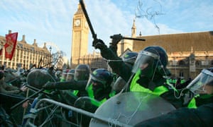 Riot police hold back demonstrators in Parliament Square
