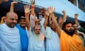 Hindu priests celebrate after hearing the first reports on the court verdict in Ayodhya, India