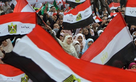 Egyptian women wave flags during a rally in Cairo's Tahrir square 