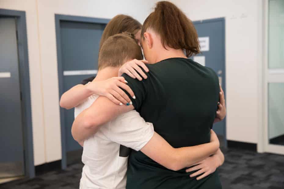 A mother hugs her kids at Dillwynia correctional centre.