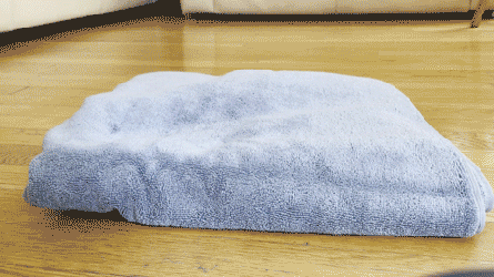 a person pressing on different towels to test fluffiness