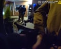 Officers handcuff the occupants and force them to sit on the pavement