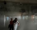 Passengers at Maiquetía airport seek cover from falling debris