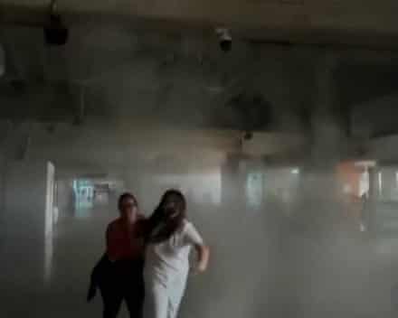 Passengers at Maiquetía airport seek cover from falling debris