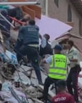 Rescue workers carry people out on stretchers in Baruta, Caracas, after earthquake in Venezuela