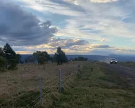 Vehicles drive along road near NSW national park where Lily Hooper’s body was discovered