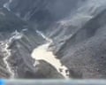Barrier lake forms at base of mountains near Nepal border