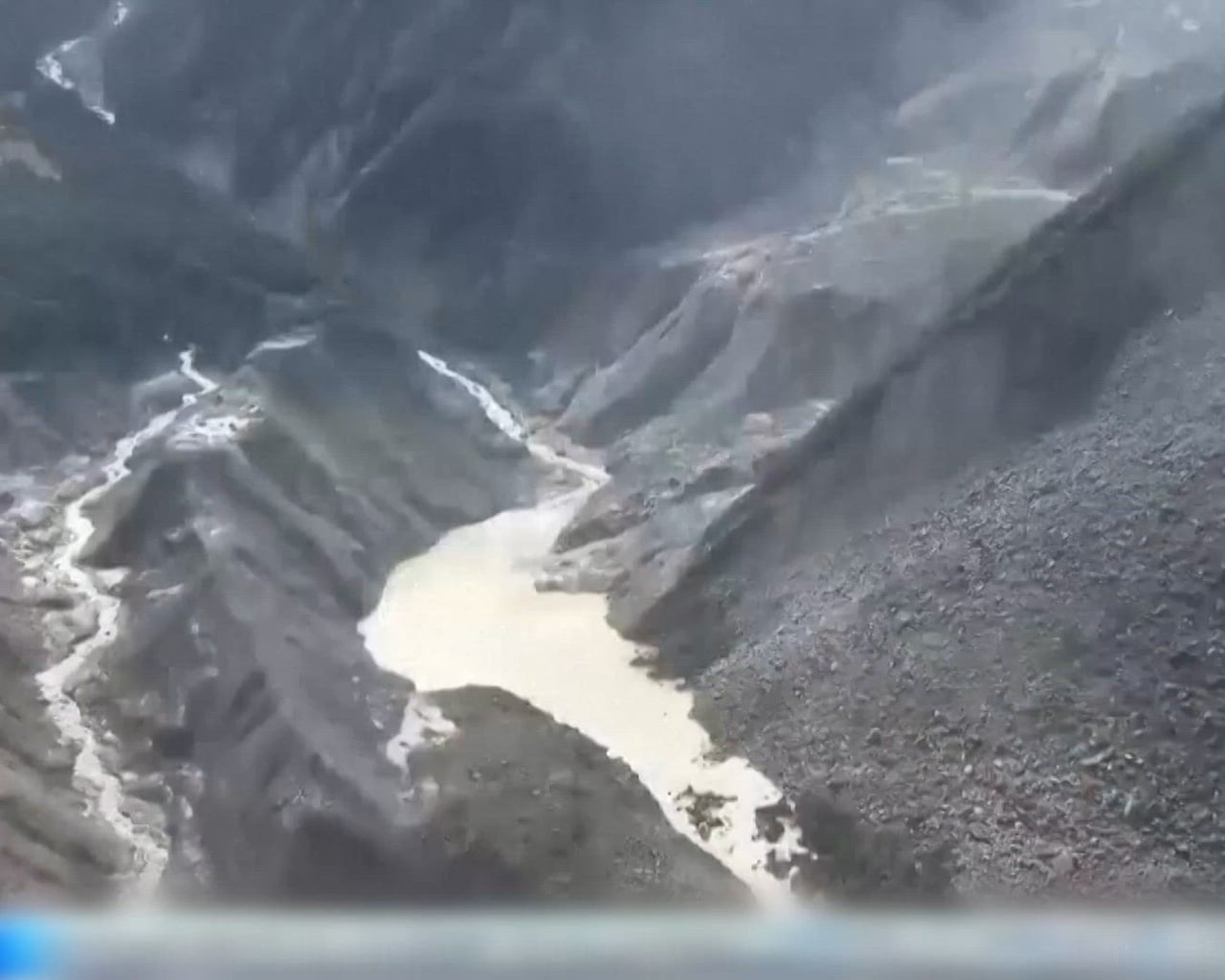 Barrier lake forms at base of mountains near Nepal border