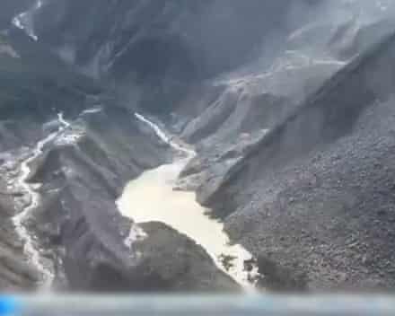 Barrier lake forms at base of mountains near Nepal border