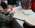 People search posters of those missing in Nepal flood