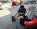 Alaa makes tea over an open flame as cooking gas is scarce in Gaza