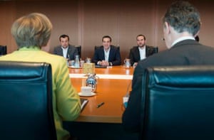 German Chancellor Angela Merkel (L) talks to Greek Prime Minister Alexis Tsipras (C) at the Chancellery in Berlin March 23, 2015.