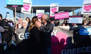 A German woman and a Greek man stage a ‘kiss marathon’ in front of the chancellery in Berlin prior to a meeting of the leaders of Greece and Germany on March 23, 2015. AFP PHOTO / JOHN MACDOUGALLJOHN MACDOUGALL/AFP/Getty Images