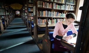 A student working in the library at Corpus Christi College at Oxford University