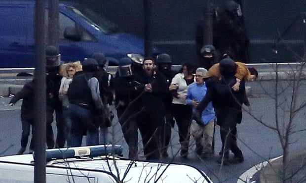 Members of the French police special forces evacuate hostages after launching the assault at a kosher grocery store in Porte de Vincennes, eastern Paris.