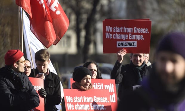Protestors hold a sign reading “We start from Greece, we change Europe” during a demonstration in front of the German Finance minstry ahead of a meeting of Greece’s new Finance Minister with his German counterpart in Berlin, on February 5, 2015.