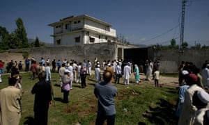 Local people and media gather outside the compound where bin Laden was killed in Abbottabad Pakistan