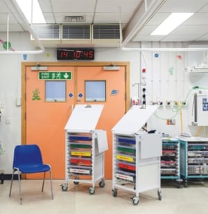 Trollies and an empty chair in a hospital room