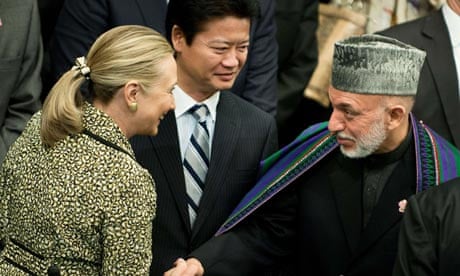 hillary clinton greets hamid karzai