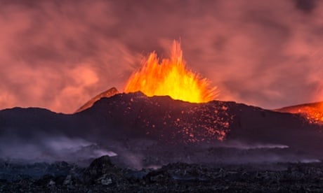 a spectacular volcanic eruption seen from a distance in