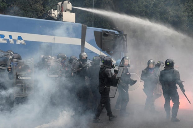 Italian riot police take position next to a water cannon during a protest against ECB policy during the meeting of ECB executives in Naples, Italy, 02 October 2014.