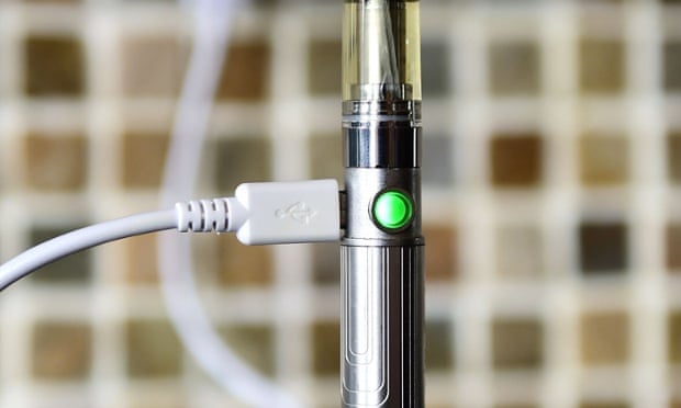 An e-cigarette charges from the wall.