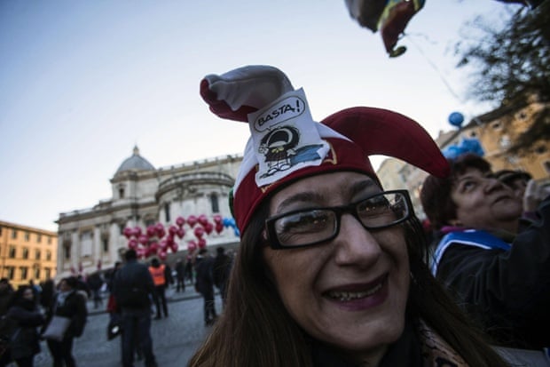 A demonstrator wears a headgear reading 'thats's enough!' as she takes part in a rally march called by CGIL and UIL, two of Italy's three big trade union confederations in Rome, Italy, 12 December 2014.