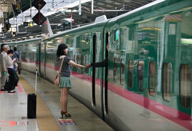 A couple say goodbye as he leaves on the Tohoku Shinkansen bullet train from Tokyo.