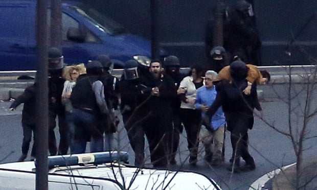Members of the French police special forces evacuate the hostages after launching the assault at a kosher grocery store in Porte de Vincennes, eastern Paris.