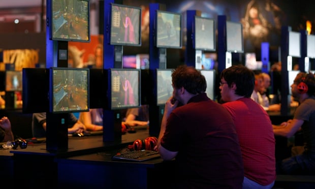 Visitors play World of Warcraft at the Blizzard Entertainment exhibition stand during the Gamescom 2014 fair in Cologne.