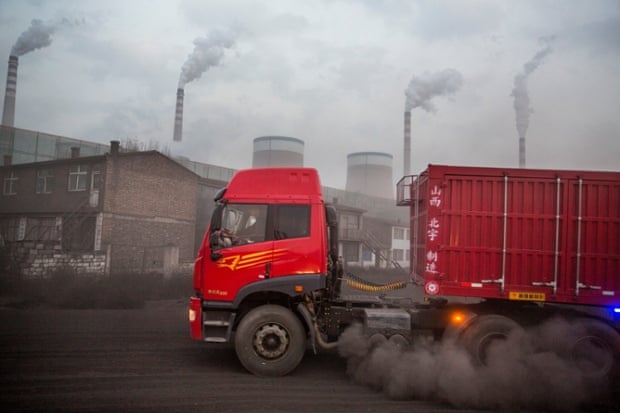 07 Nov 2013, Datong, Shanxi Province, China --- China, Shanxi Province, Datong, Trucks driving along dust-covered access road to deliver coal to Datong No. 2 Power Station