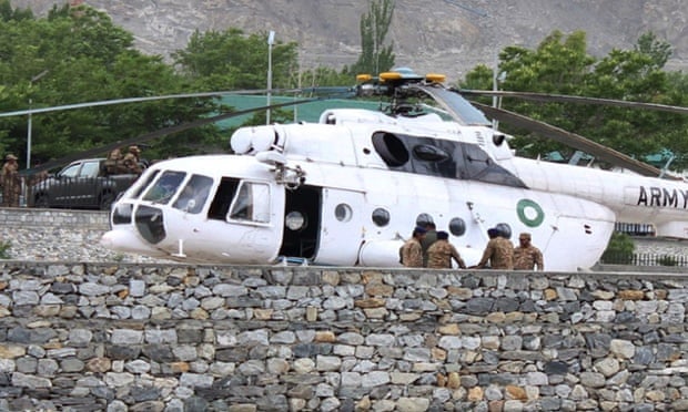 Pakistani soldiers gather beside an army helicopter at a military hospital where victims of a helicopter crash were brought for treatment in Gilgit.