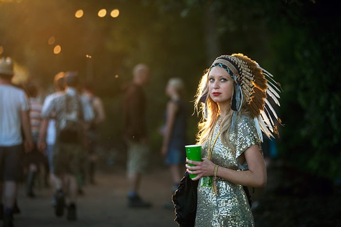 Glastonbury: A woman wearing and Indian headdress, Glastonbury Festival