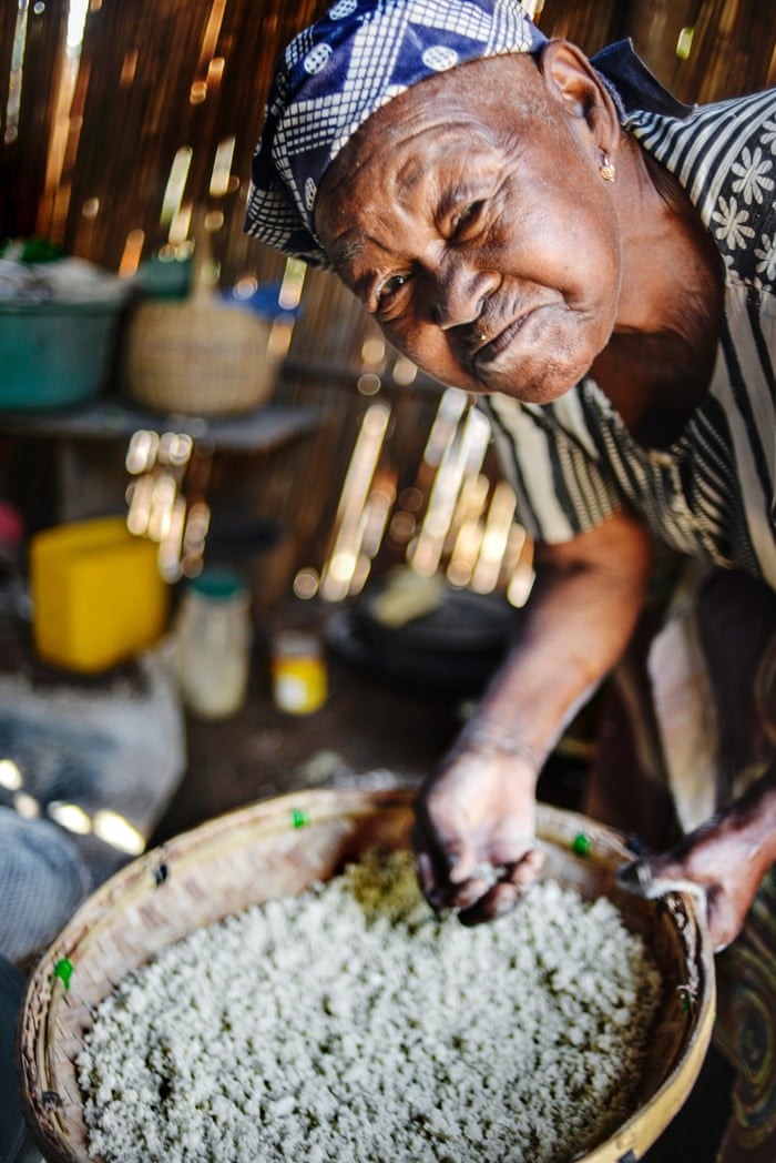 Angelina Tovele grinds cassava into flour