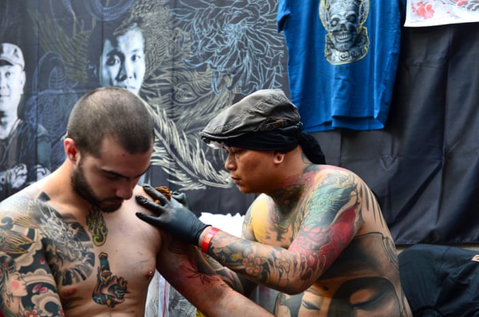 Ching tattooing at the London Tattoo convention at Tobacco Dock.