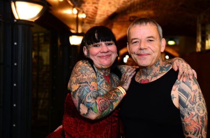 A couple pose as they attend the London Tattoo Convention at Tobacco Dock.