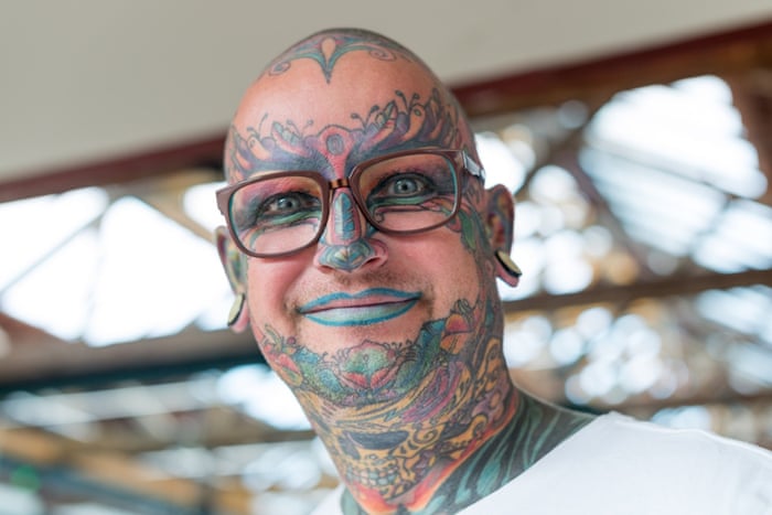 A person with their face tattooed attends the 10th London Tattoo Convention.