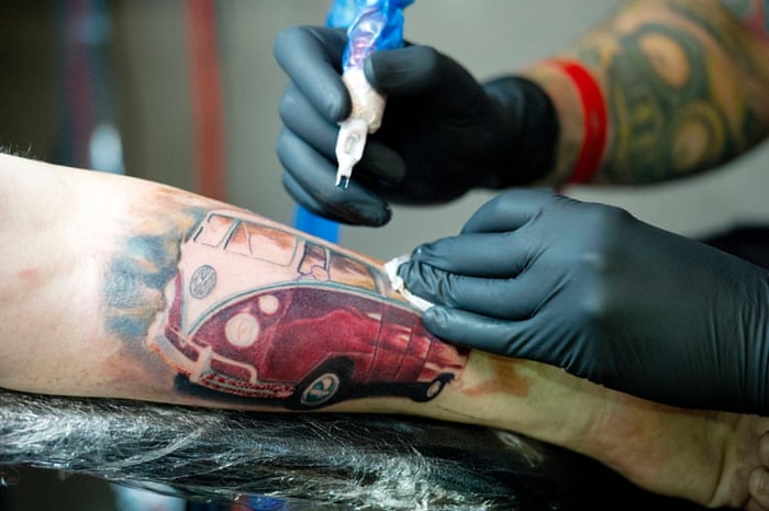 Kieran Brown gets a VW van tattooed onto his arm at the 10th London International Tattoo Convention, east London