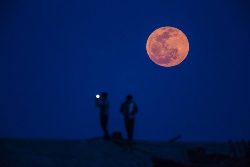 A man takes a picture in a suburb of Shanghai.